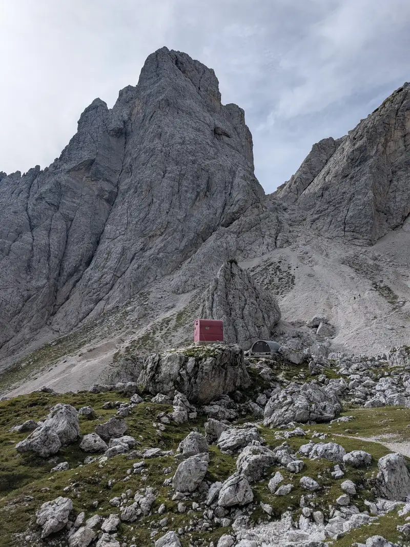 C.A.I. Gorizia bivouac and refuge in the shadows of Cima alta di Rio Bianco. We go past these huts and up to the visible saddle (Forcella alta di Riobianco) where Sentiero del Centenario route starts.