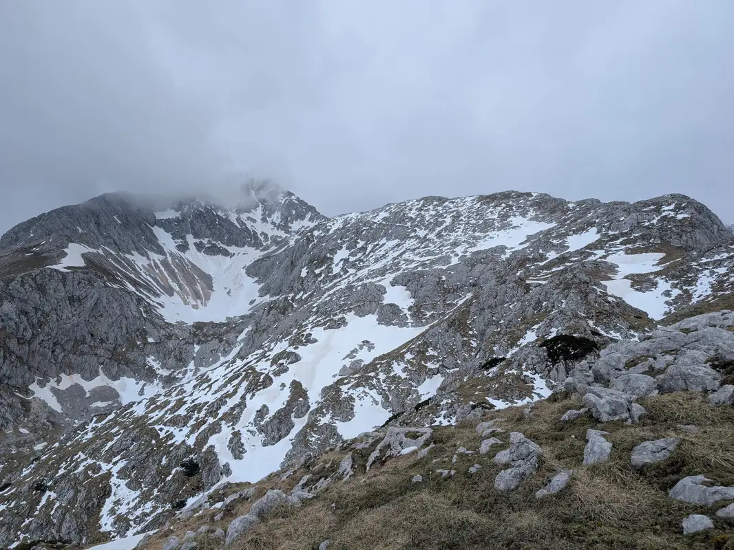 From now we can take a good look on Dolge stene ridge on the right, being, covered in clouds is peak of Grintovec.