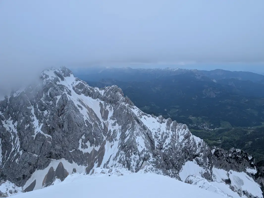 View from the Grintovec peak into north-western direction with Jezerska Kočna in the foreground and Košuta massif in Karavanks in the background.