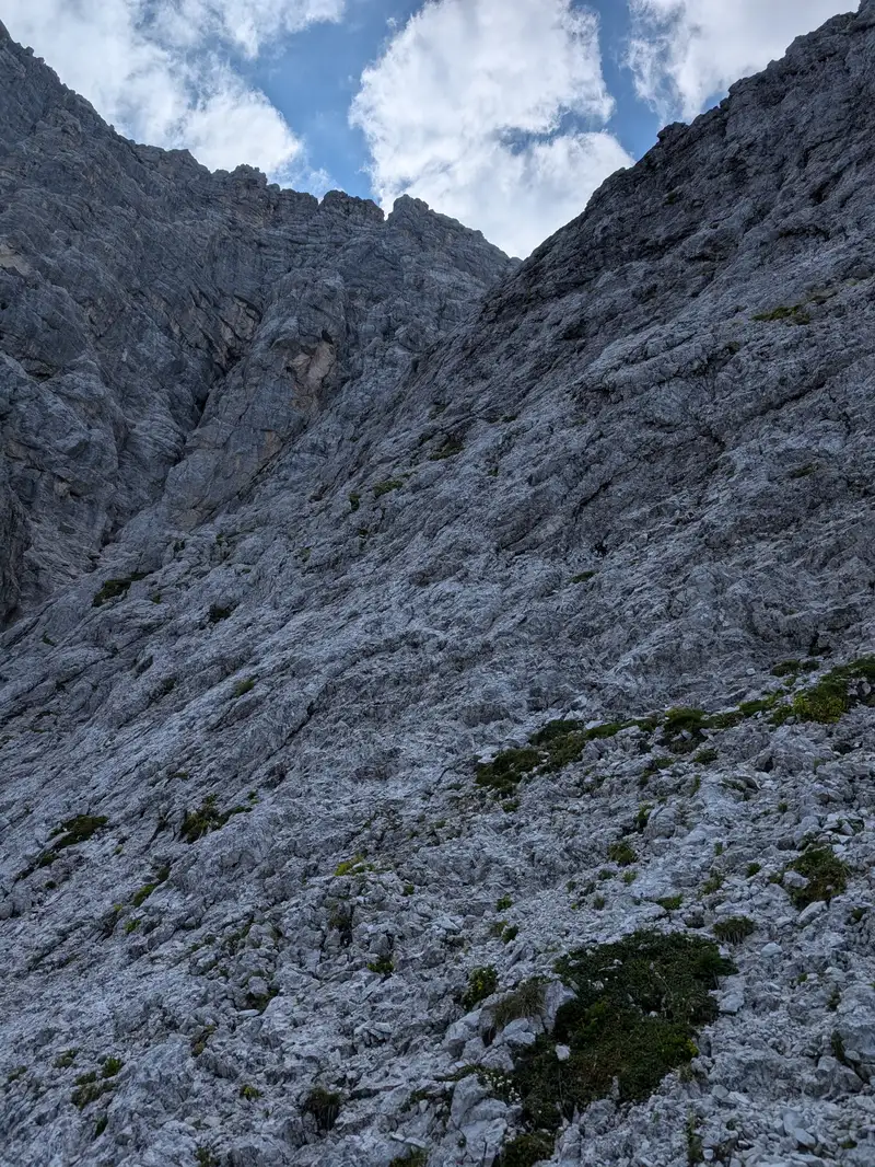 Main part of the climb, trying to find the most approachable way in direction of the tower with yellow broken rock. Doesn't look difficult however gets a bit exposed in the upper part (II).