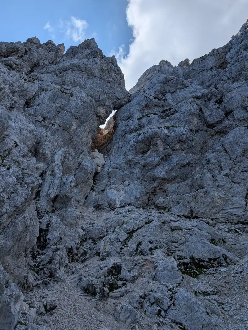 Famous Jôf Fuart tunne window. We still go up from here and keep to the left to involve in a slightly descending traverse.
