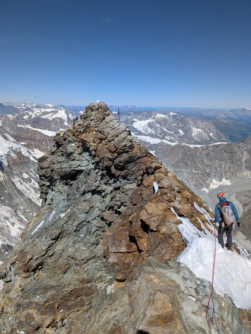 Italian peak of Matterhorn / Monte Cervino (4476m) observed from the ridge between itself and Swiss peak (4478m). Italian one is oftentimes devoid of snow while Swiss has it. Crossing the ridge was possible without winter equipment.