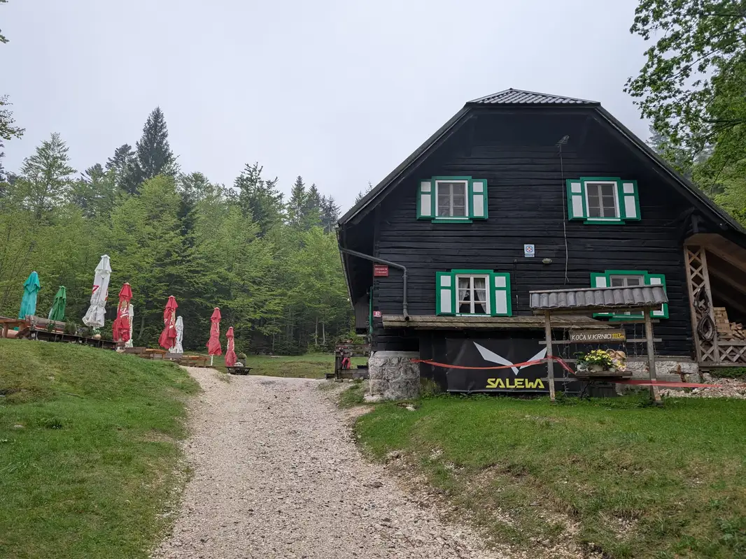 Koča v Krnici mountain hut, that's a sign we need to turn left behind that rows of garden umbrellas.
