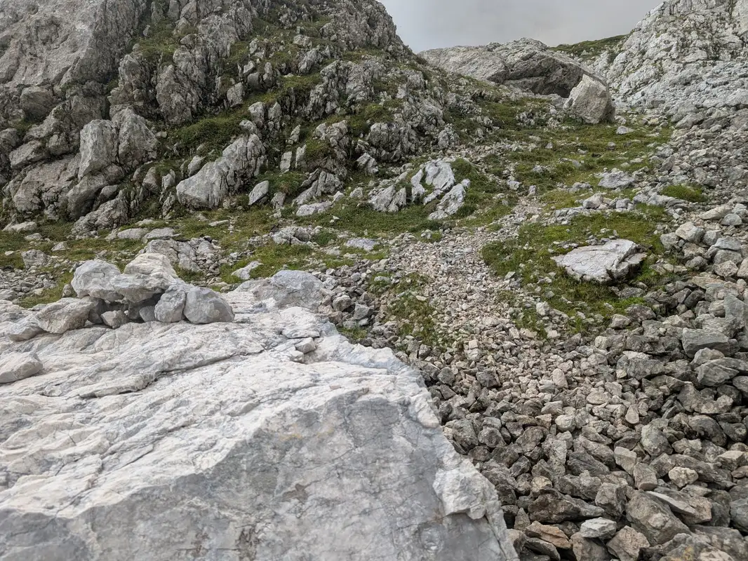 There are some cairns amd indistinct path but walking up with intuition should be enough.