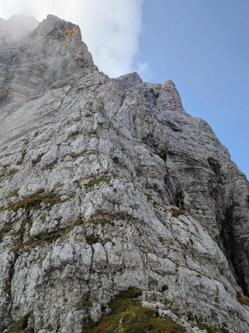 View from the start of the route, pitches 1,2,3 can be seen from here - third pitch finishes under these yellow slabs but a bit to the right. These 3 pitches are fragile and require meticulous hand- and footwork. Thanks to the ridge formation the risk of stones falling from above on belayer is minimised.