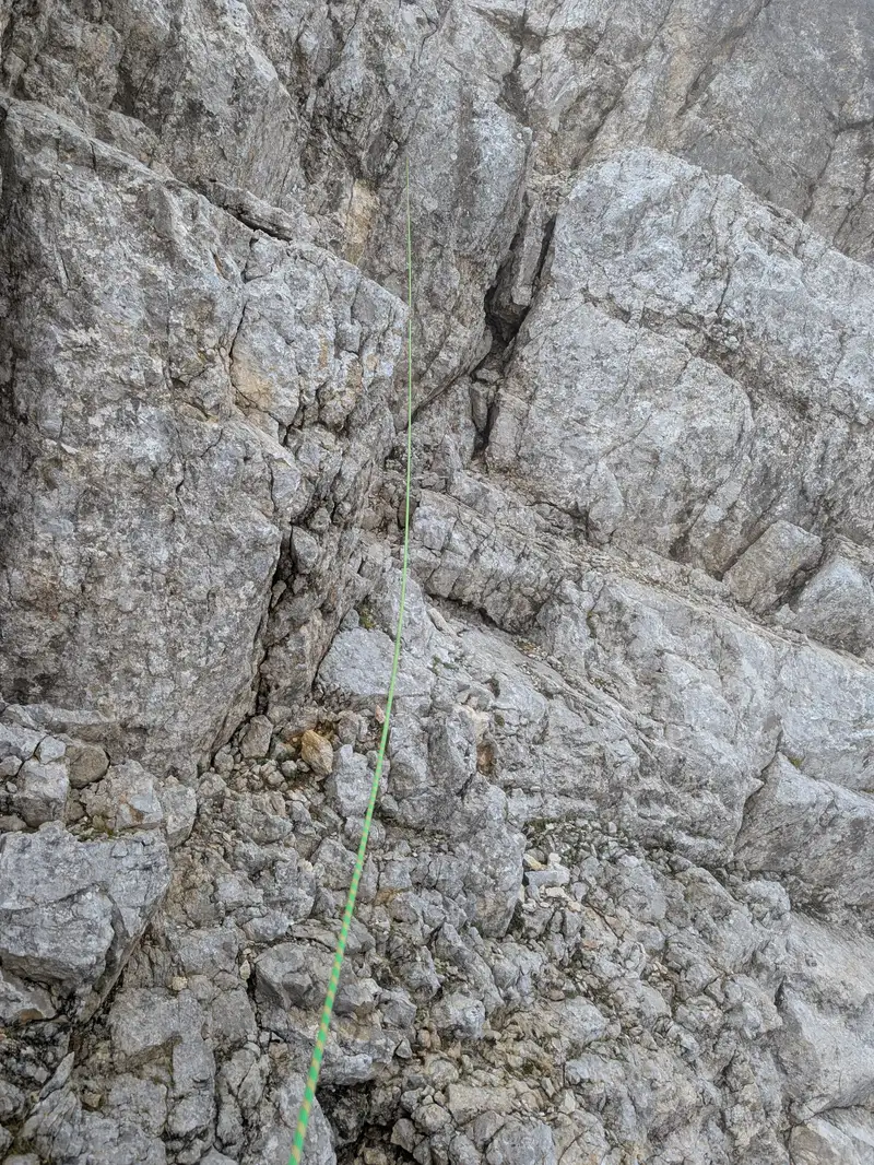 Climbing below blocky towers in the seventh pitch (topo says to go above them). Chimney with jammed rock proved to be most challenging (III+)