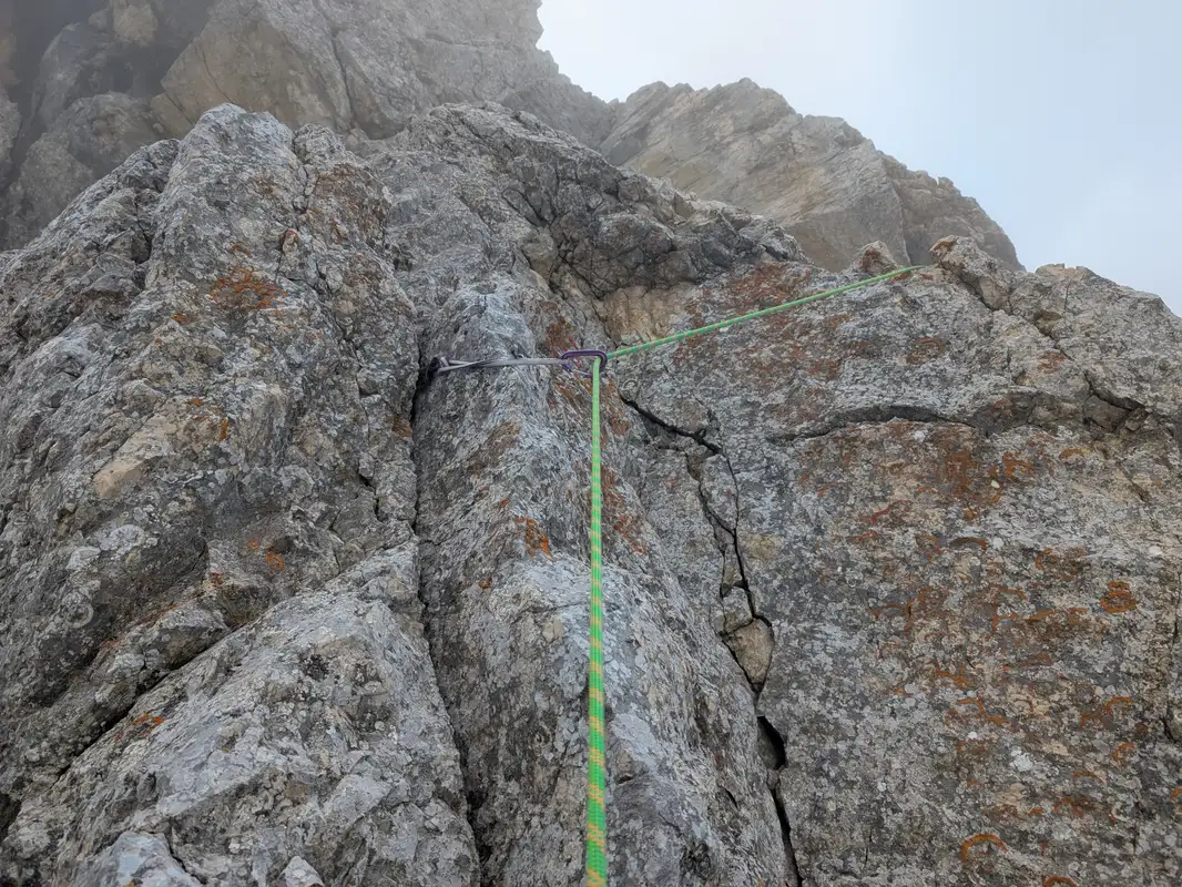 Not sure if part of the original route because of probable rockfall, here we need to climb on the left and then traverse and climb down along that ledge where the rope runs.