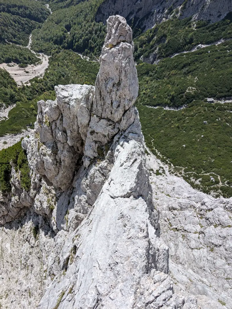 A view back on the ridge and location of fifth belay below that rocky tower. Highlight of the route, good rock and exposition.