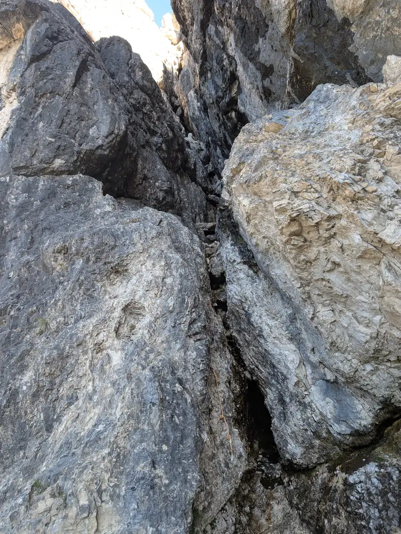 At the mouth of the entry chimney to the ramp. Where the rock is black it is also wet. Luckily in these places we are basically walking and then immediately leaving the chimney to the right. Attaco diretto!
