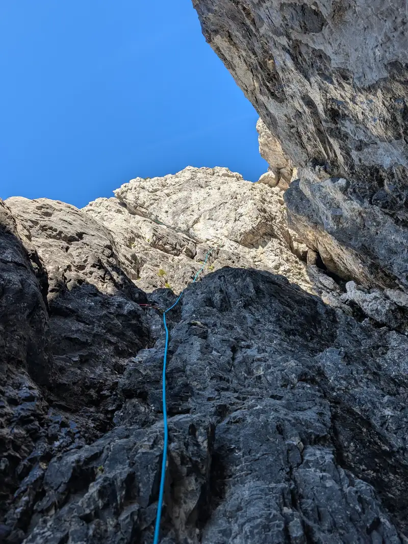 Terrain in the first pitch after leaving the actual chimney, up like the rope directs. Second belay is next to that jammed rock on right.